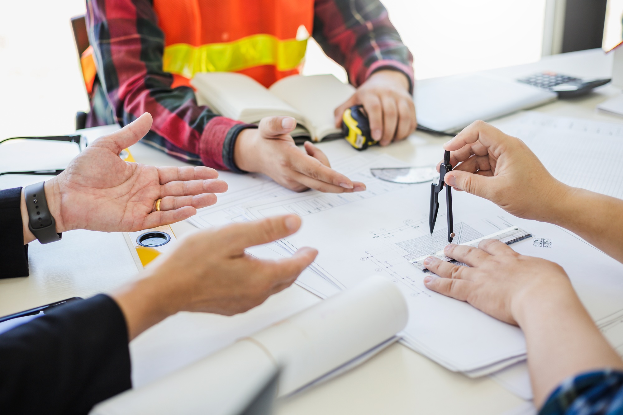 Engineer and contractor planning projects together at the meeting.