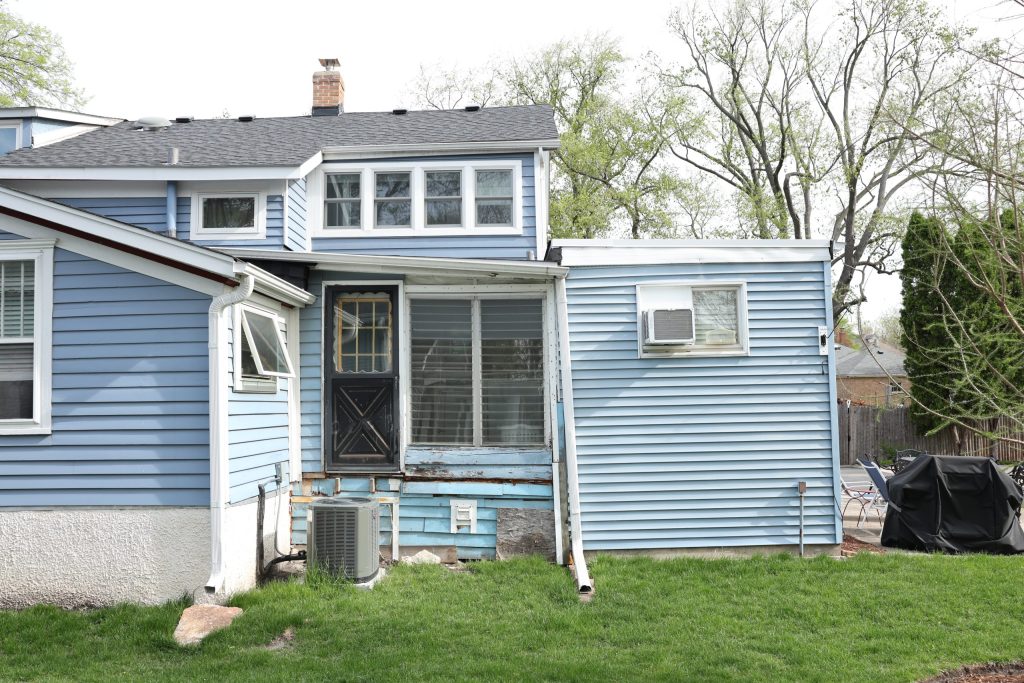 Rear view of Lombard farmhouse showing multiple mismatched additions before renovation